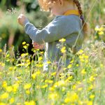 Student in a flower meadow.