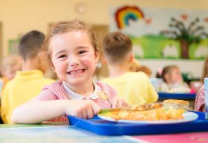 Student eating school dinner.